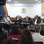 Imagem de plateia de costas olhando para mesa com vereadores e representantes da sociedade civil