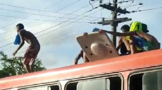 pessoas "surfando" em ônibus